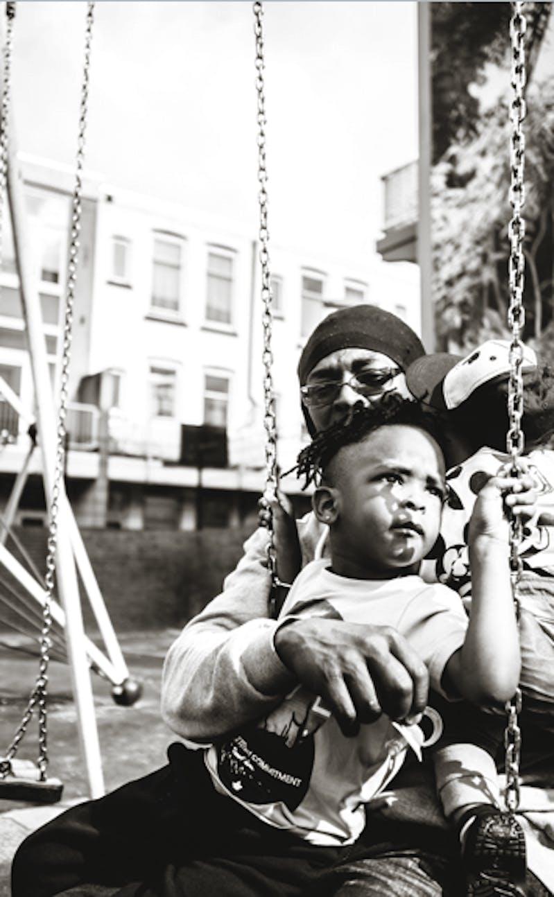 Little child with mother on a swing in balck and white
